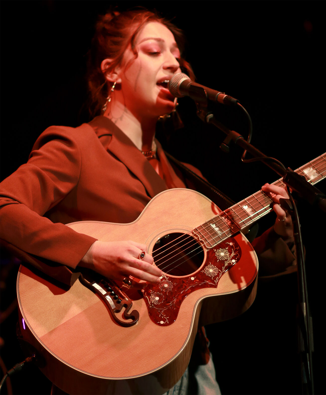 Abbey Cone plays the guitar and sings